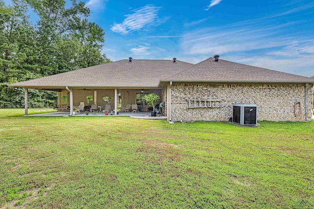 rear view of property with a lawn, central AC, ceiling fan, and a patio area