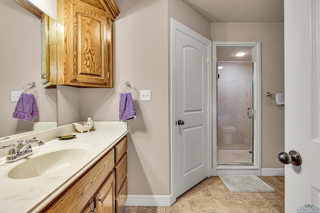 bathroom with vanity and a shower with shower door