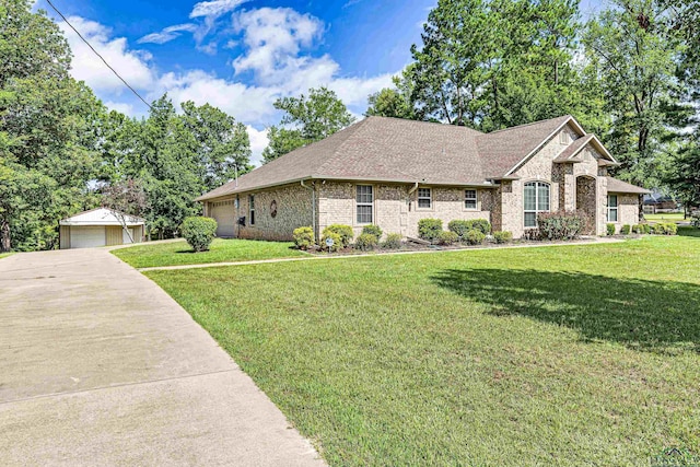 view of front of property with an outbuilding, a front lawn, and a garage