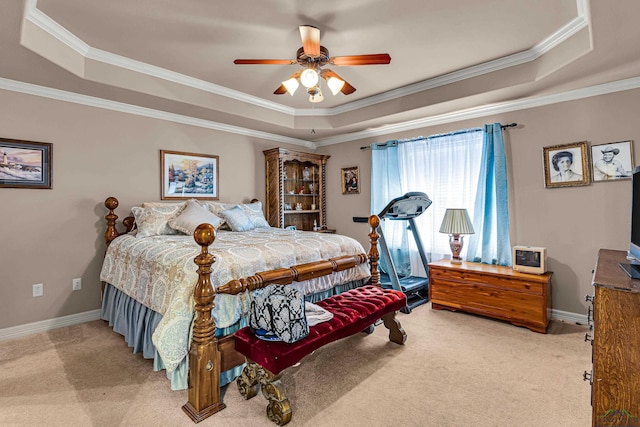 carpeted bedroom featuring a raised ceiling, ceiling fan, and crown molding