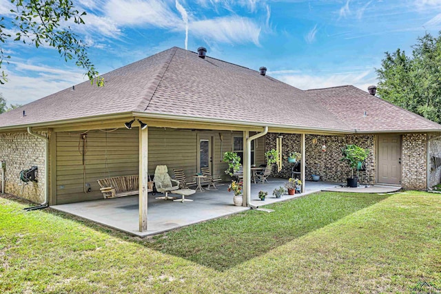 rear view of house with a patio area and a yard