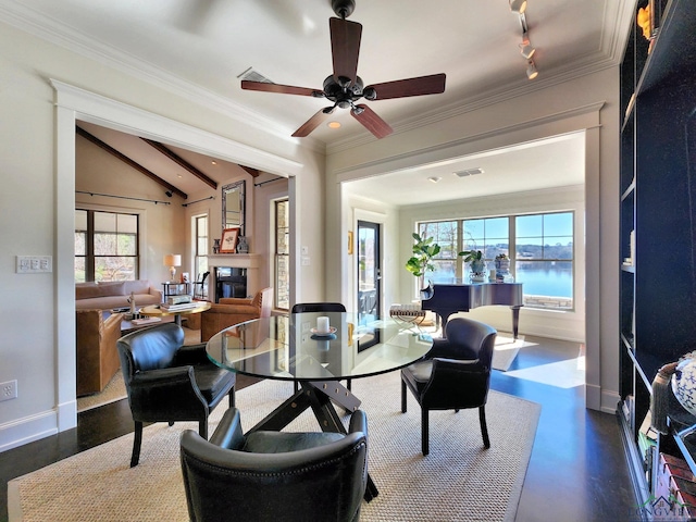 dining space with crown molding, vaulted ceiling, ceiling fan, and a water view