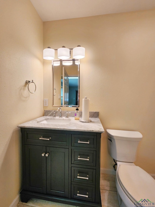 bathroom with vanity, tile patterned flooring, and toilet