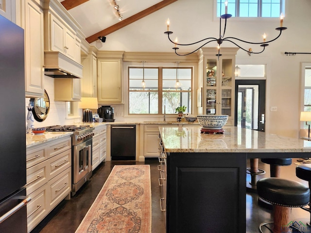 kitchen featuring premium range hood, a kitchen bar, vaulted ceiling with beams, light stone counters, and stainless steel appliances