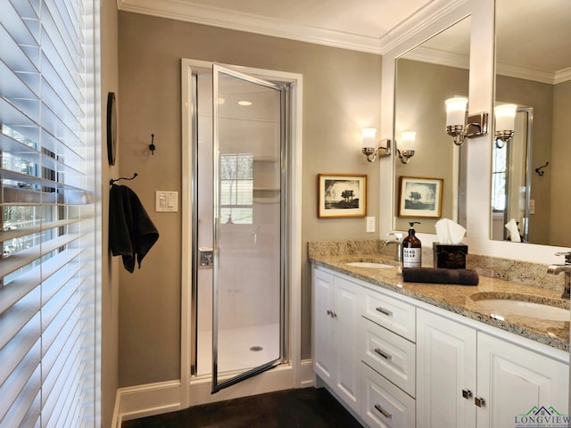 bathroom featuring ornamental molding, a shower with door, and vanity