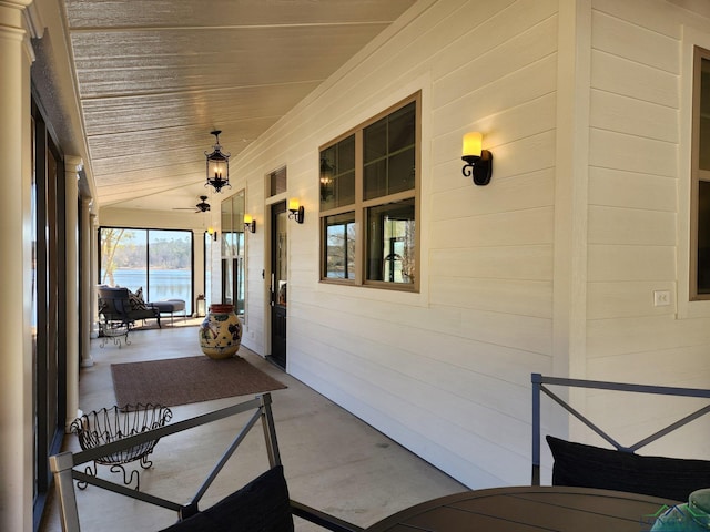 unfurnished sunroom with wood ceiling, ceiling fan, and lofted ceiling