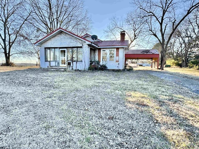 view of front facade with a carport and a front lawn