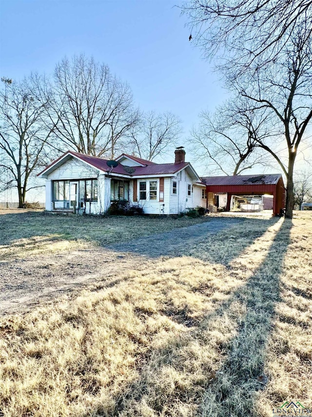 rear view of house featuring a lawn