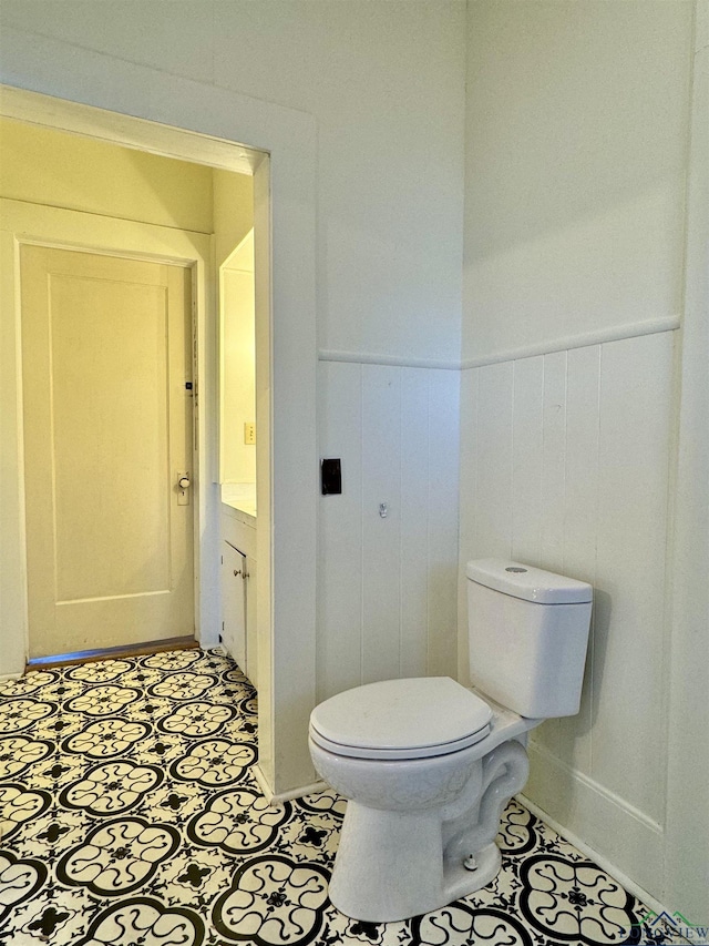 bathroom featuring vanity, tile patterned floors, and toilet