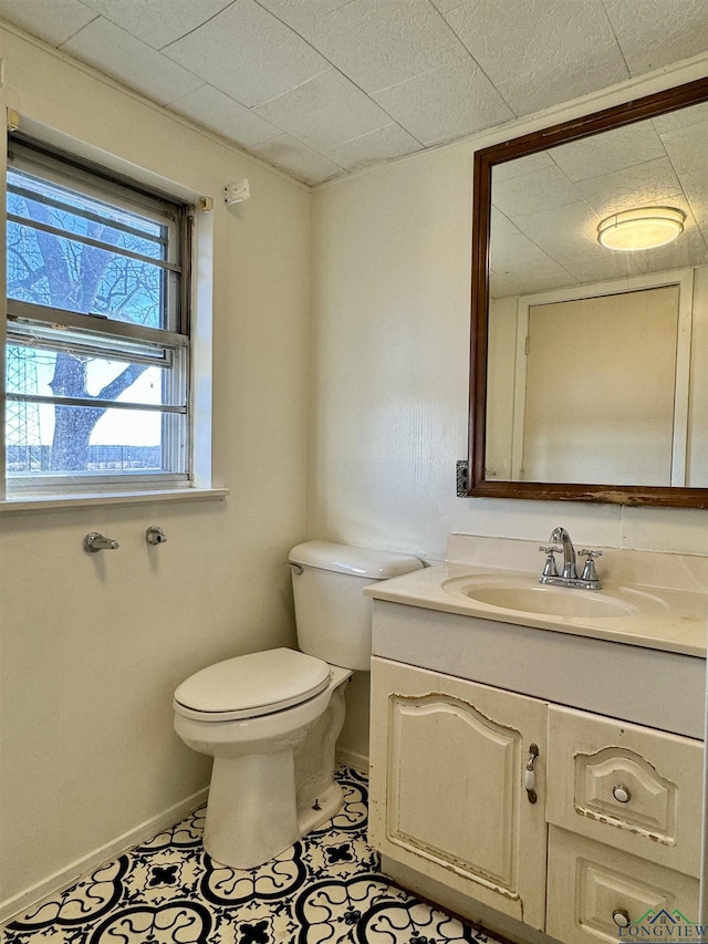 bathroom featuring vanity, toilet, and tile patterned flooring