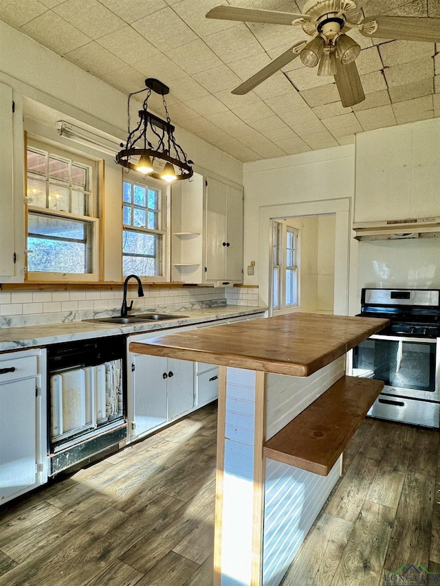 kitchen with butcher block counters, white cabinetry, decorative light fixtures, dark hardwood / wood-style flooring, and stainless steel range with electric cooktop