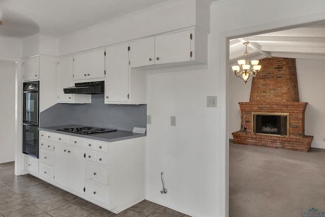 kitchen featuring an inviting chandelier, ventilation hood, gas stovetop, tasteful backsplash, and white cabinetry