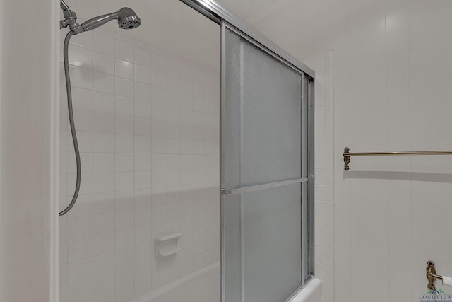 bathroom featuring shower / bath combination with glass door