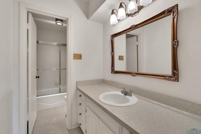 full bathroom with combined bath / shower with glass door, vanity, toilet, and tile patterned flooring