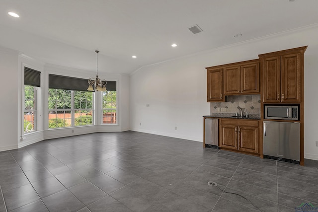 kitchen featuring crown molding, stainless steel microwave, and a chandelier