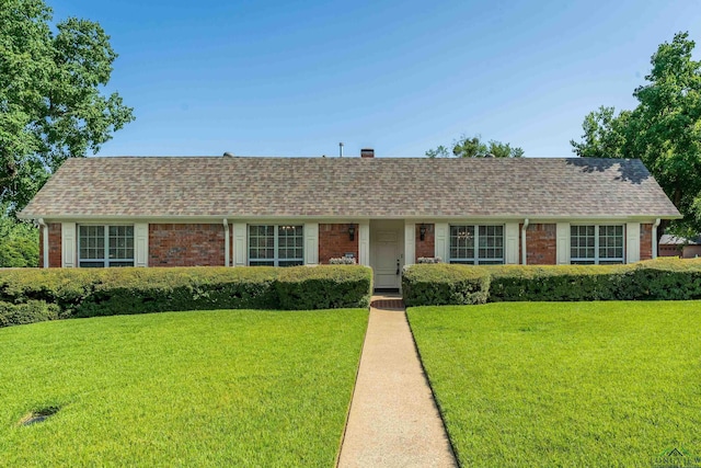 ranch-style home with a front lawn