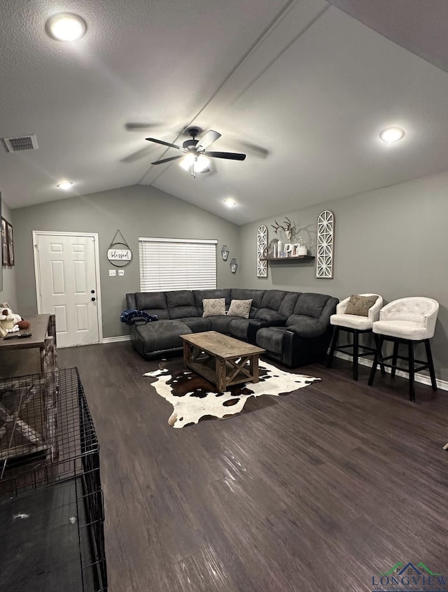 living room featuring ceiling fan, dark hardwood / wood-style flooring, and vaulted ceiling