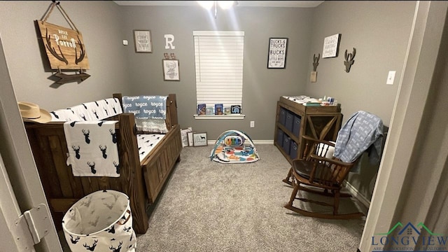 bedroom with carpet floors and baseboards