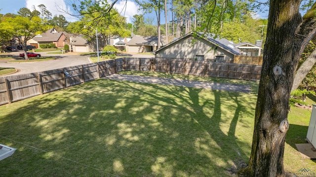 view of yard featuring a residential view and a fenced backyard