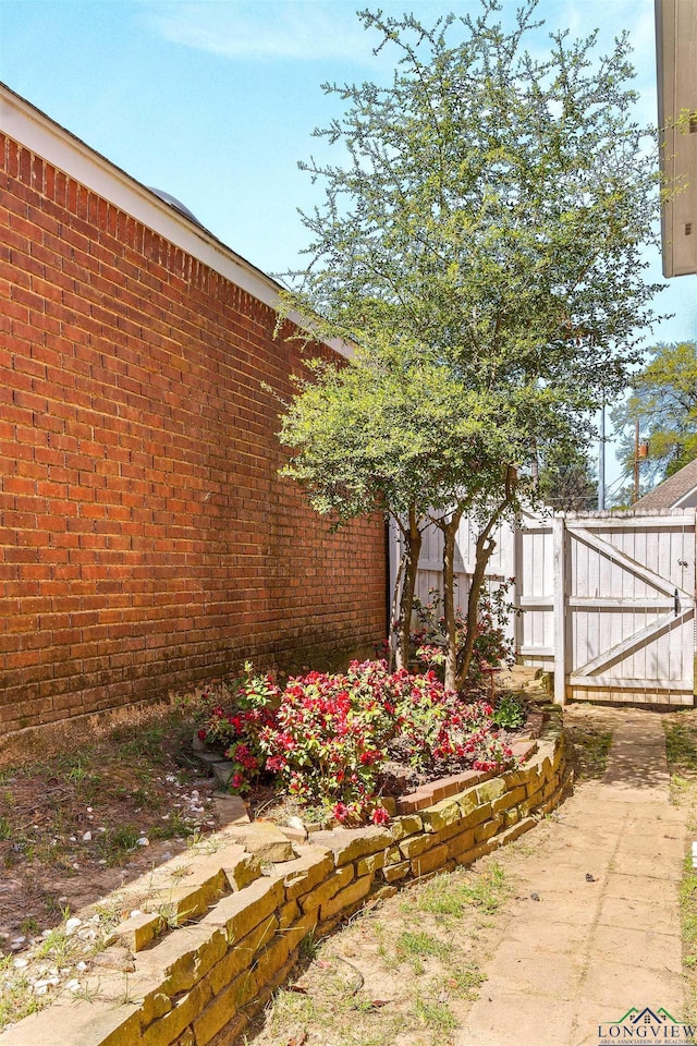 view of yard with fence and a gate