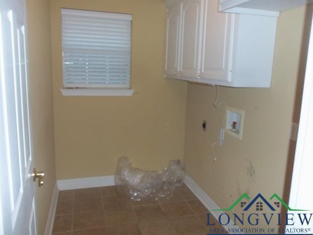 laundry area featuring electric dryer hookup, hookup for a washing machine, cabinets, and tile patterned flooring