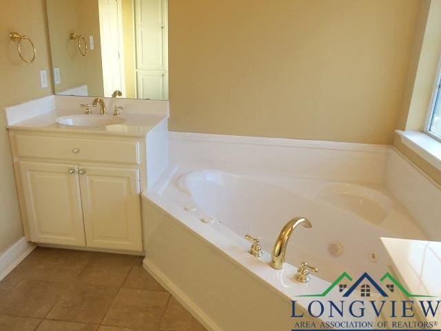 bathroom featuring vanity, tile patterned floors, and a tub