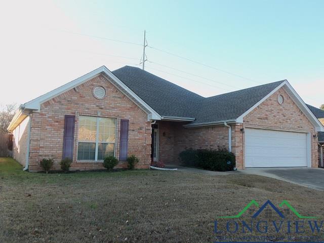 ranch-style house with a front yard and a garage