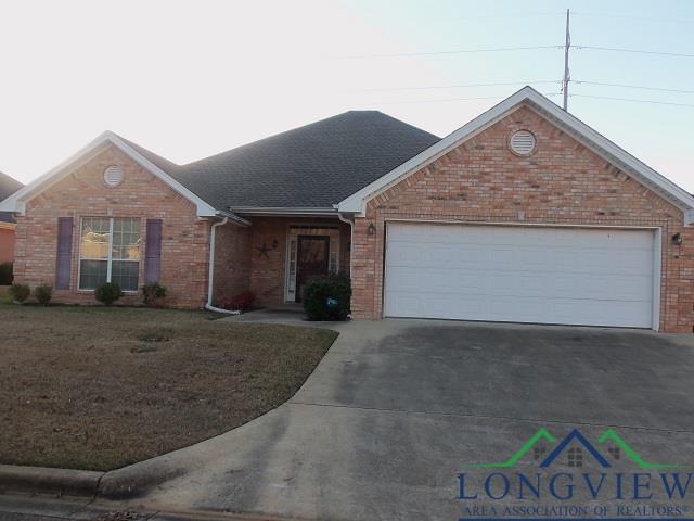 view of front of house with a garage and a front lawn