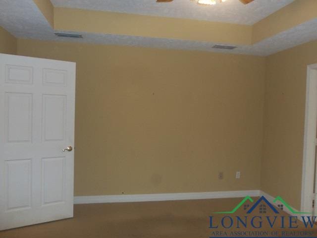 spare room with ceiling fan and a textured ceiling