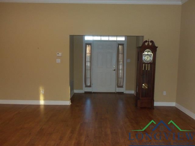 foyer entrance featuring dark hardwood / wood-style floors and ornamental molding