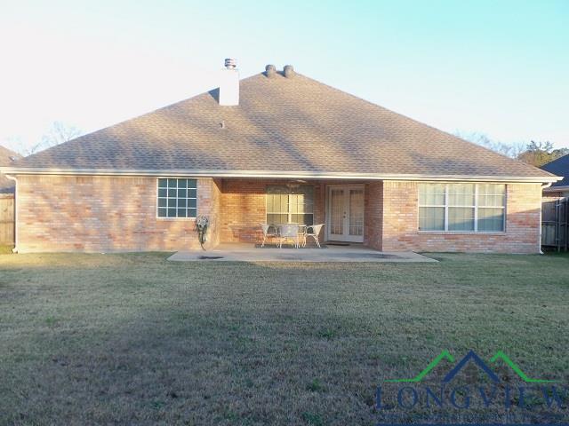 back of house with french doors, a patio area, and a lawn