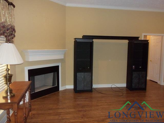 living room with dark hardwood / wood-style flooring and crown molding