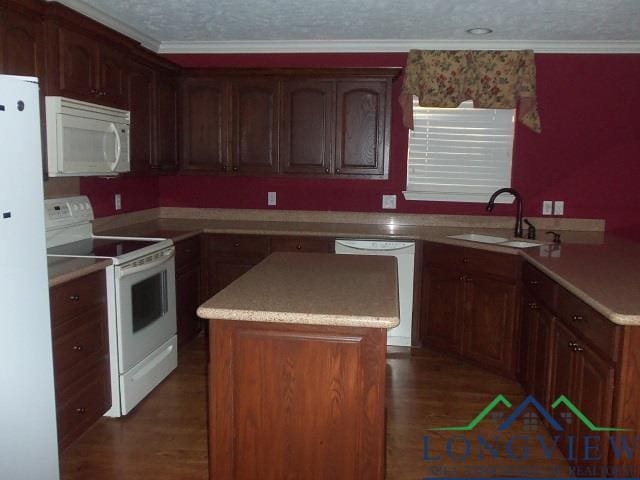 kitchen featuring dark hardwood / wood-style flooring, crown molding, white appliances, and sink