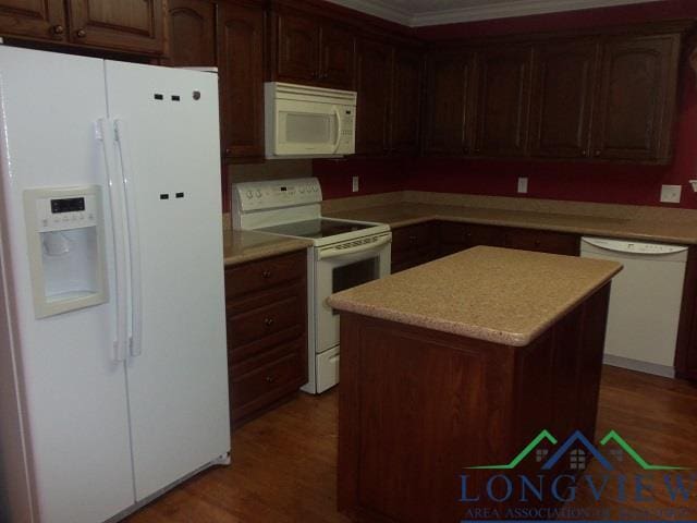 kitchen with a center island, white appliances, crown molding, dark hardwood / wood-style floors, and dark brown cabinets