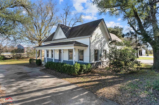 view of side of property with a porch