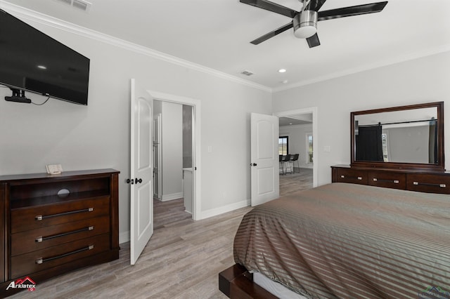 bedroom with baseboards, visible vents, light wood-style flooring, ceiling fan, and ornamental molding