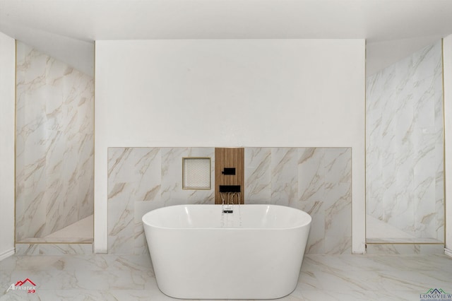 full bathroom with a marble finish shower, a freestanding tub, and marble finish floor