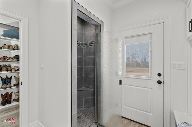 bathroom featuring a shower stall and wood finished floors