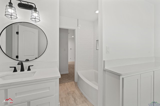 full bathroom with shower / washtub combination, wood finished floors, and vanity