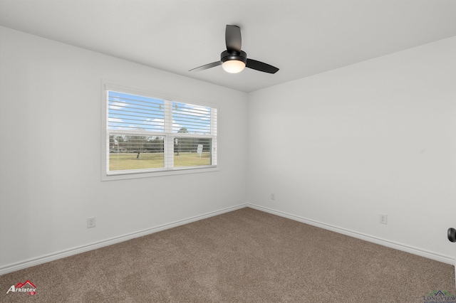 carpeted empty room with baseboards and a ceiling fan