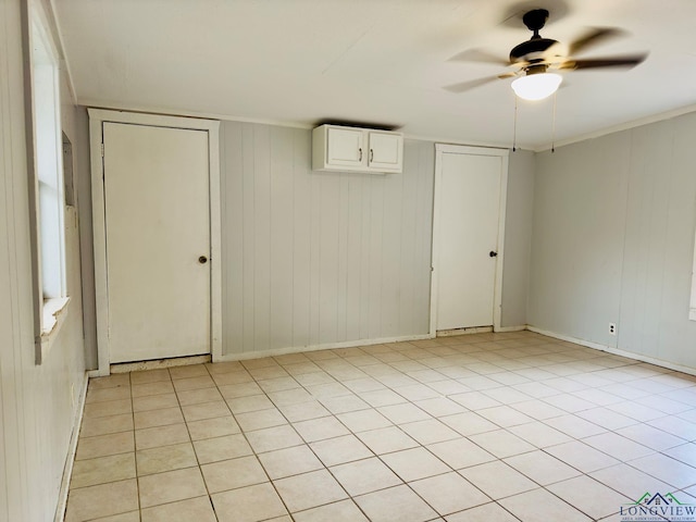 unfurnished room with light tile patterned floors and ceiling fan