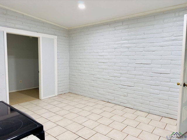 unfurnished room featuring crown molding and brick wall