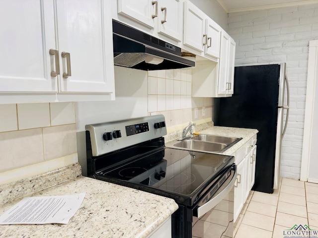 kitchen featuring light stone counters, stainless steel range with electric stovetop, sink, white cabinets, and light tile patterned flooring