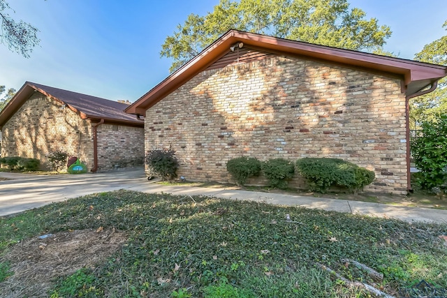 view of property exterior featuring brick siding