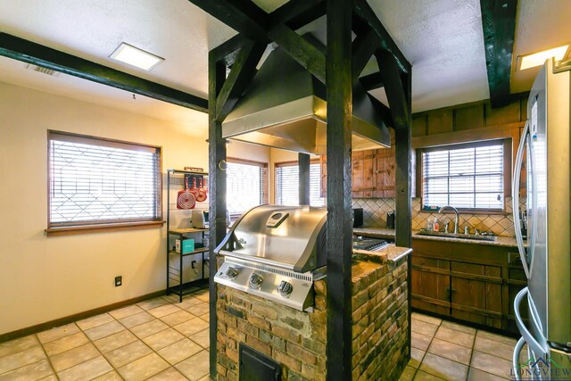 view of patio / terrace featuring exterior kitchen, area for grilling, and a sink
