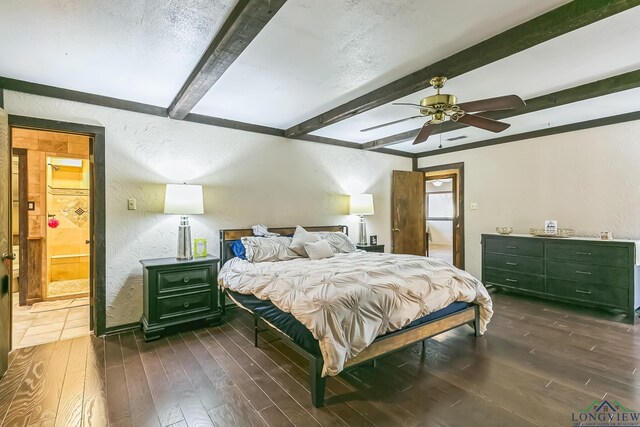 bedroom with hardwood / wood-style floors, a ceiling fan, a textured wall, and beam ceiling