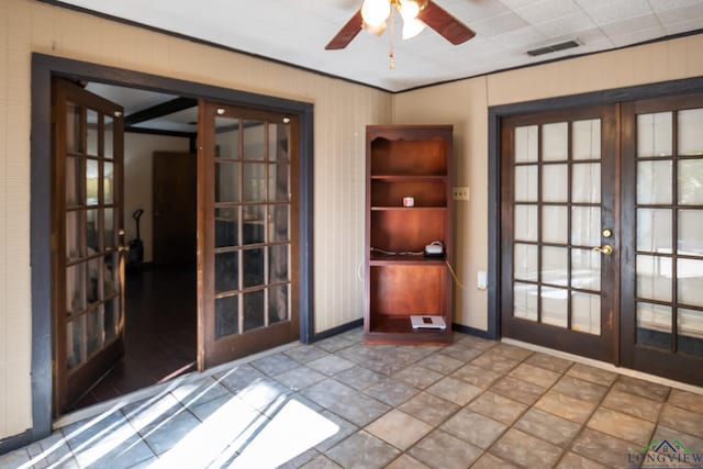 interior space with french doors, ornamental molding, baseboards, visible vents, and a ceiling fan
