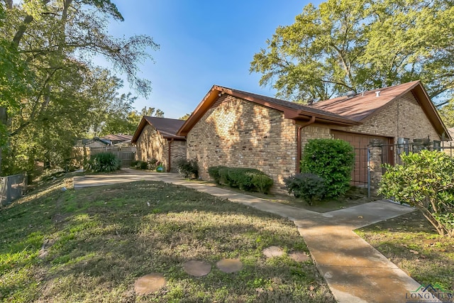 view of front of home featuring a front yard, fence, and brick siding