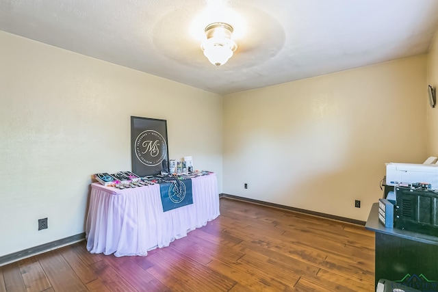 misc room with hardwood / wood-style floors and baseboards