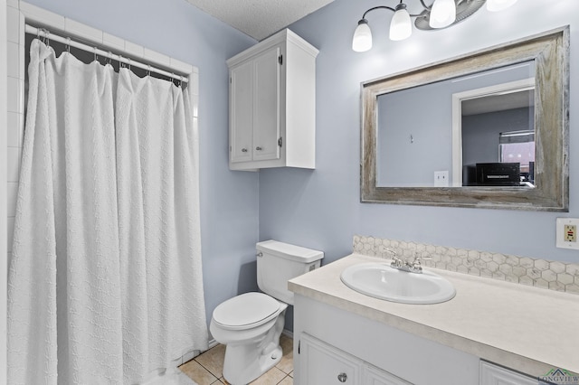 bathroom with walk in shower, tile patterned floors, toilet, a textured ceiling, and vanity